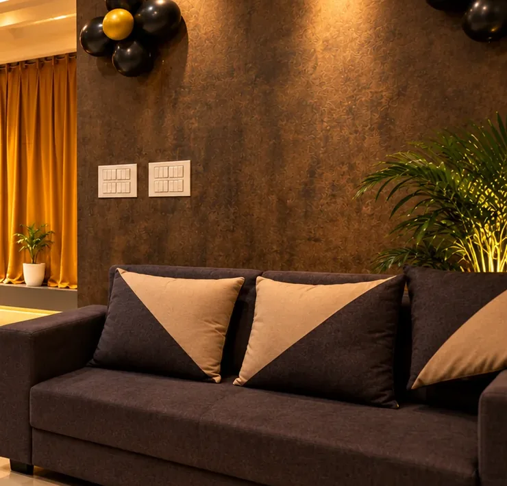 TANGLE Signature dark lounge sofa and gold-accented wall